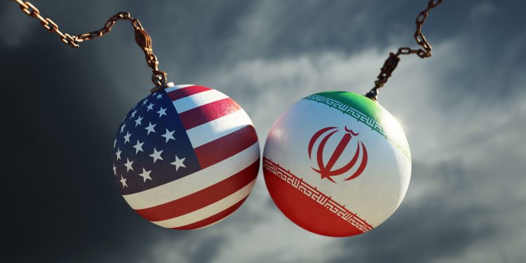 Wrecking balls textured with American and Iranian flags over dark stormy sky. Horizontal composition with copy space and selective focus. Dispute concept.