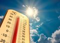 climate change, low angle view Thermometer on blue sky with sun shining in summer show increase temperature, concept global warming
